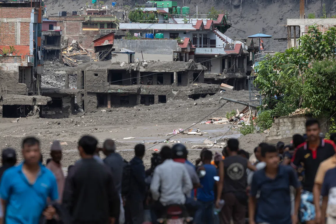 epa13193026 People watch as floodwaters sweep through Trishuli Bazar following a flash flood, in Nuwakot district, Nepal, 26 August 2026. Several people were killed and multiple others were reported missing after a massive flash flood swept through Rasuwa and Nuwakot districts causing widespread destruction to settlements and infrastructure, according to local authorities. EPA/NARENDRA SHRESTHA