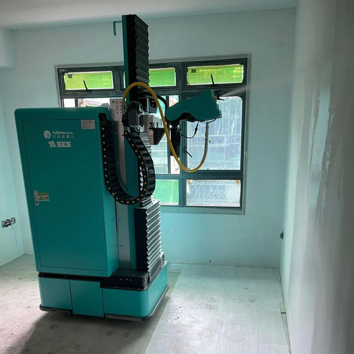 A painting robot at work in a Build-To-Order project construction site.