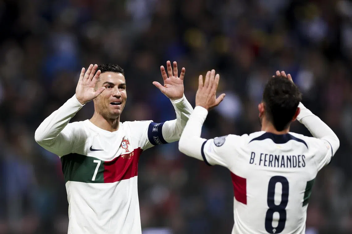 Portugal's Cristiano Ronaldo celebrating his goal with teammate Bruno Fernandes during their Euro qualifying match against Bosnia & Herzegovina in Zenica.
