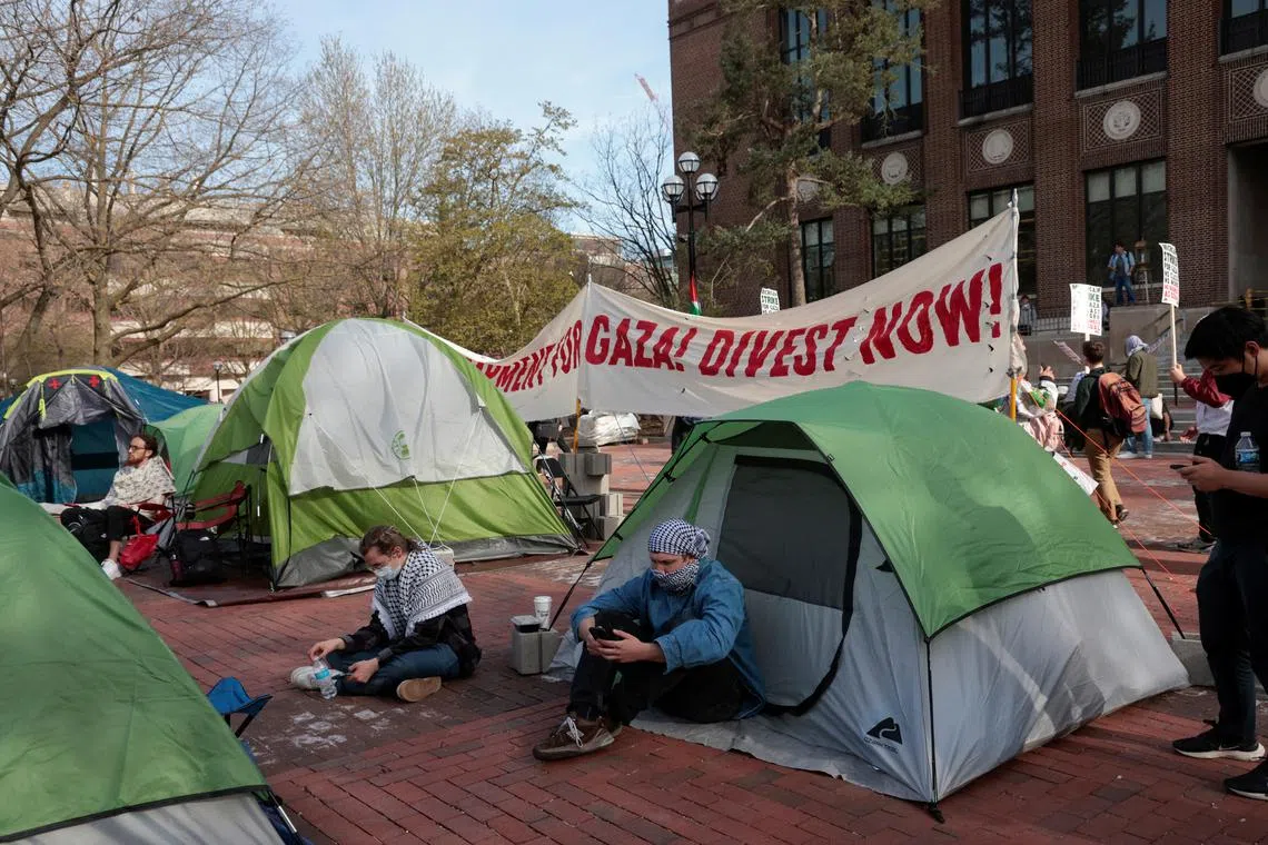 A coalition of University of Michigan students rally at an encampment in the Diag to pressure the university to divest its endowment from companies that support Israel or could profit from the ongoing conflict between Israel and the Palestinian Islamist group Hamas, on the University of Michigan college campus in Ann Arbor, Michigan, U.S., April 22, 2024. REUTERS/Rebecca Cook/File Photo