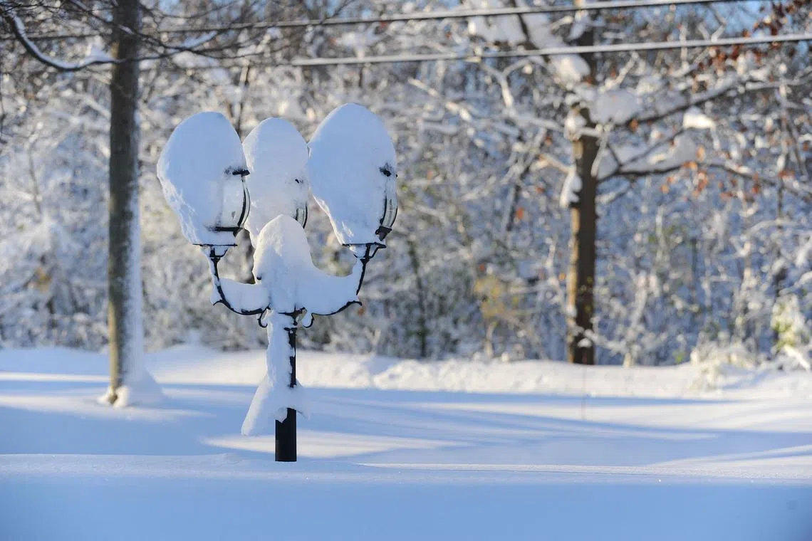 HAMBURG, NY - NOVEMBER 19: A lamp post protrudes from the snow after an intense lake-effect snowstorm impacted the area on November 19, 2022 in Hamburg, New York. Around Buffalo and the surrounding suburbs, the snowstorm resulted in up to five feet of accumulation and additional snowfall is forecast for the weekend. The band of snow is expected to return to the same hard hit areas and has resulted in at least two deaths.   John Normile/Getty Images/AFP (Photo by John Normile / GETTY IMAGES NORTH AMERICA / Getty Images via AFP)