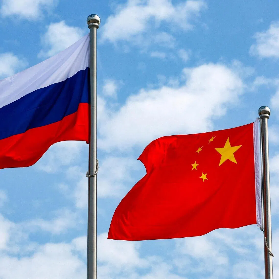 FILE PHOTO: Chinese and Russian flags fly at an airport before a ceremony to welcome Russian President Vladimir Putin, who arrives to attend the Shanghai Cooperation Organisation (SCO) summit in Tianjin, China August 31, 2025. Sputnik/Vladimir Smirnov/Pool via REUTERS ATTENTION EDITORS - THIS IMAGE WAS PROVIDED BY A THIRD PARTY./File Photo