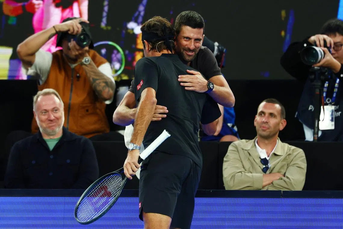 Tennis - Australian Open - Melbourne Park, Melbourne, Australia - January 17, 2026 Serbia's Novak Djokovic hugs former tennis playes Roger Federer during the exhibition match REUTERS/Tingshu Wang