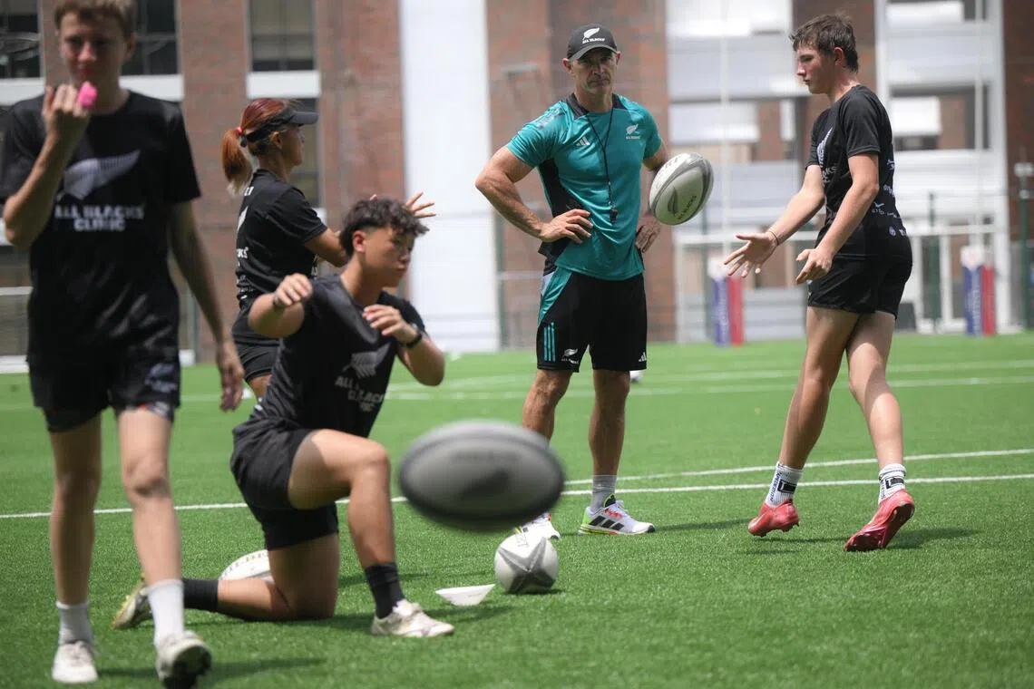 Retired New Zealand rugby union player Stephen Donald (centre), 41, supervises a rugby clinic at Tanglin Trust School on October 23, 2025.