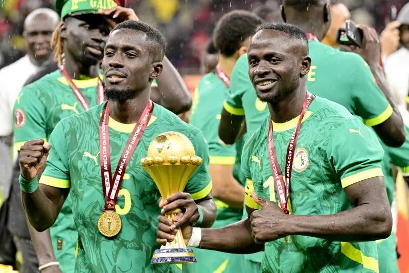  Idrissa Gueye (left) and Sadio Mane of Senegal celebrate holding the trophy after winning the CAF Africa Cup of Nations after the final match between Senegal and Morocco.