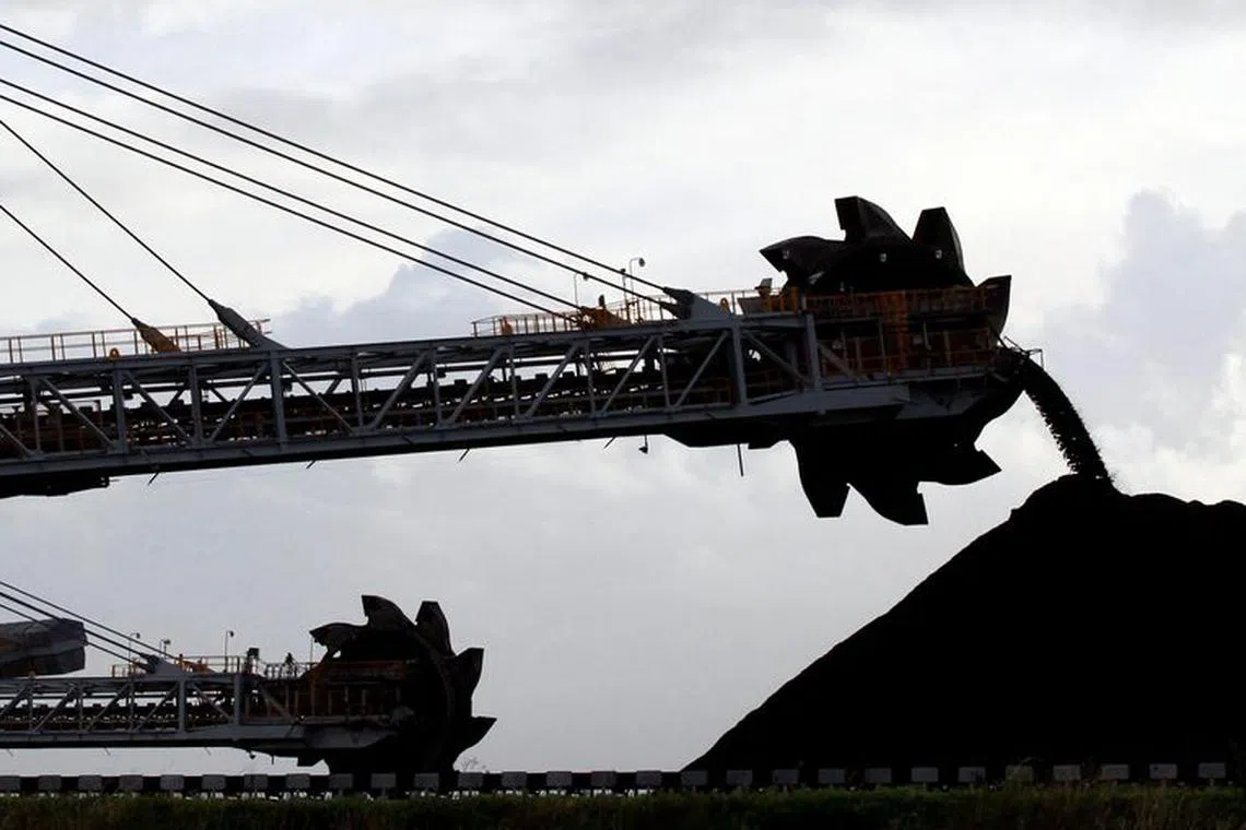 FILE PHOTO: A stacker/reclaimer places coal in stockpiles at the coal port in Newcastle June 6, 2012./File Photo