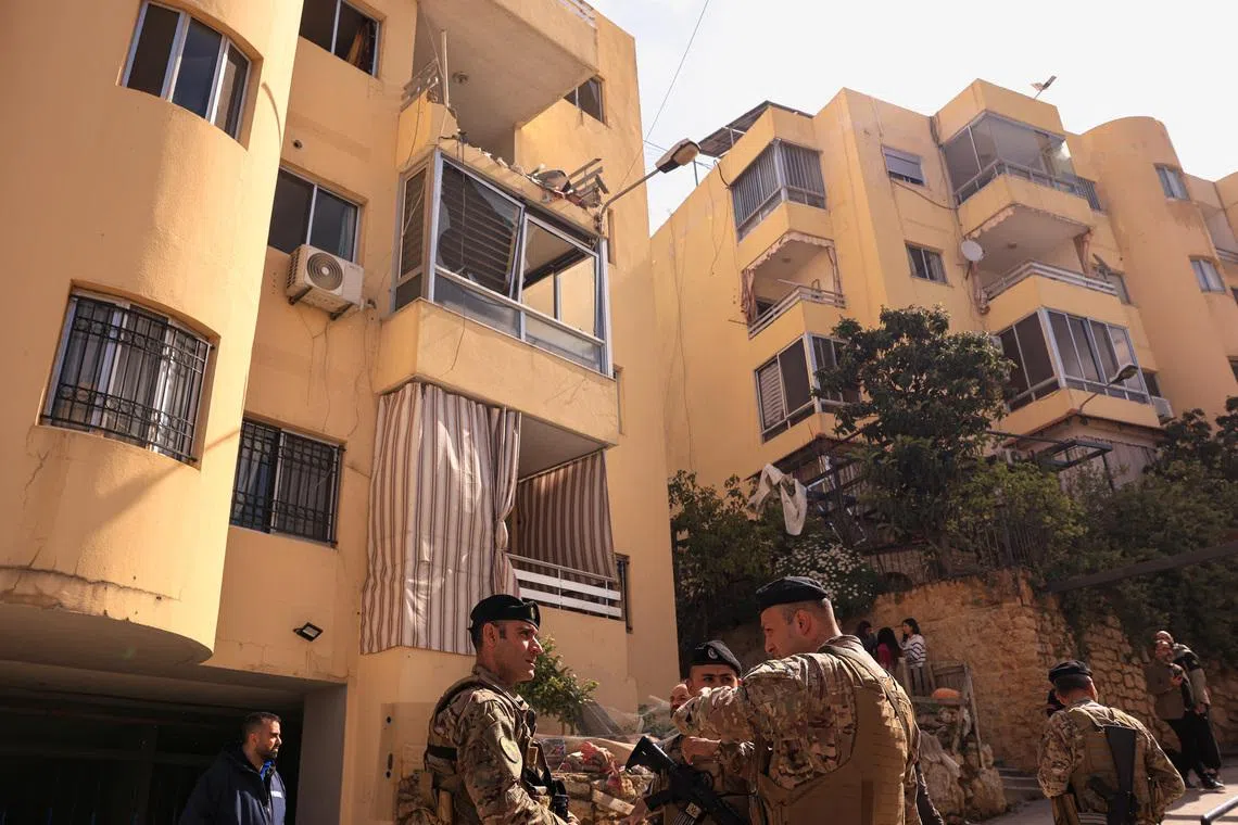 Lebanese Army servicemen stand near an apartment building hit by an Israeli strike amid escalating hostilities between Israel and Hezbollah, as the U.S.-Israel conflict with Iran continues, in Ain Saadeh, Lebanon, April 6, 2026.