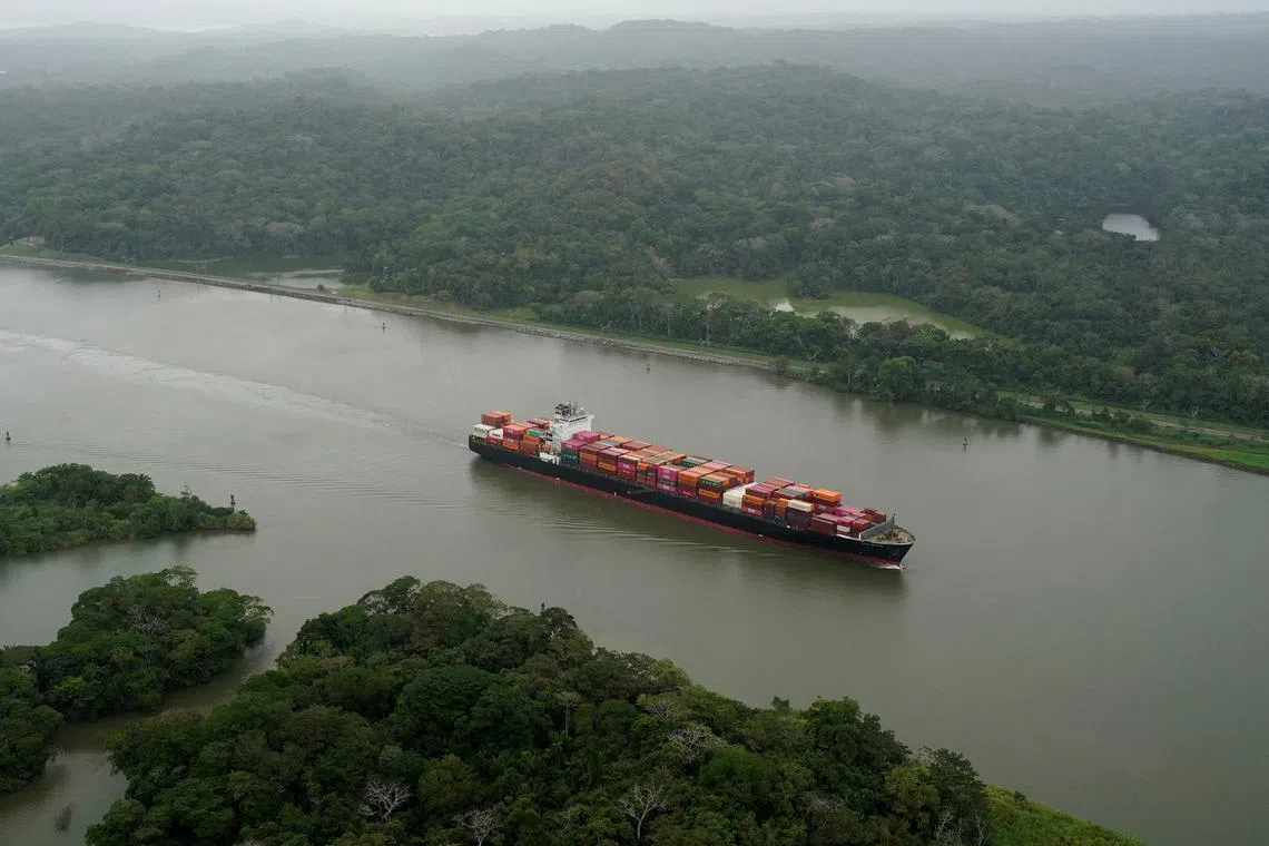FILE PHOTO: An aerial view shows a cargo ship transiting through the Panama Canal as U.S. President Donald Trump plans to regain control of the Canal, in Panama City, Panama, February 1, 2025. REUTERS/Enea Lebrun/File Photo