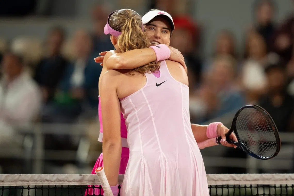 Jun 2, 2026; Paris, France; Mirra Andreeva at the net with Sorana Cirstea of Romania after their match on day 10 at Stade Roland Garros. Mandatory Credit: Susan Mullane-Imagn Images