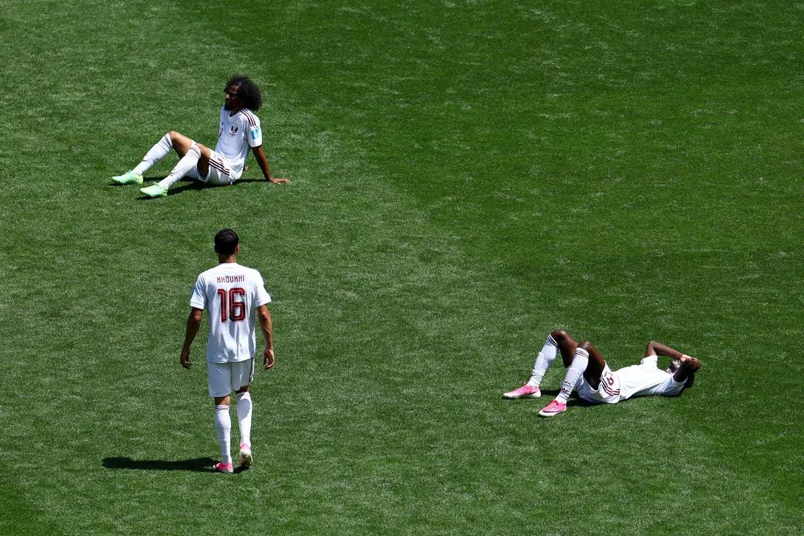 Soccer Football - FIFA World Cup 2026 - Group B - Bosnia and Herzegovina v Qatar - Seattle Stadium, Seattle, Washington, U.S. - June 24, 2026 Qatar's Akram Afif, Almoez Ali and Boualem Khoukhi look dejected after the match REUTERS/Eloisa Lopez