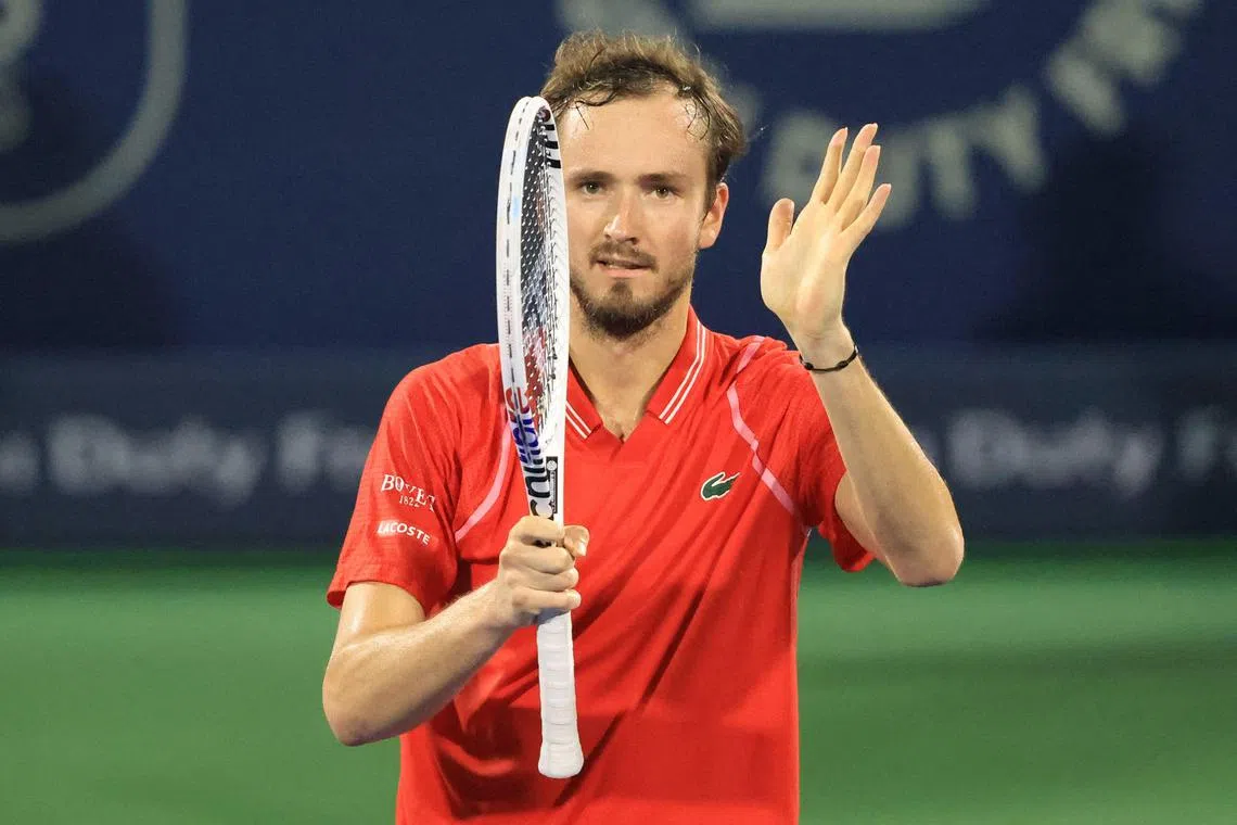 Russia's Daniil Medvedev celebrates winning against Serbia's Novak Djokovic in Dubai.