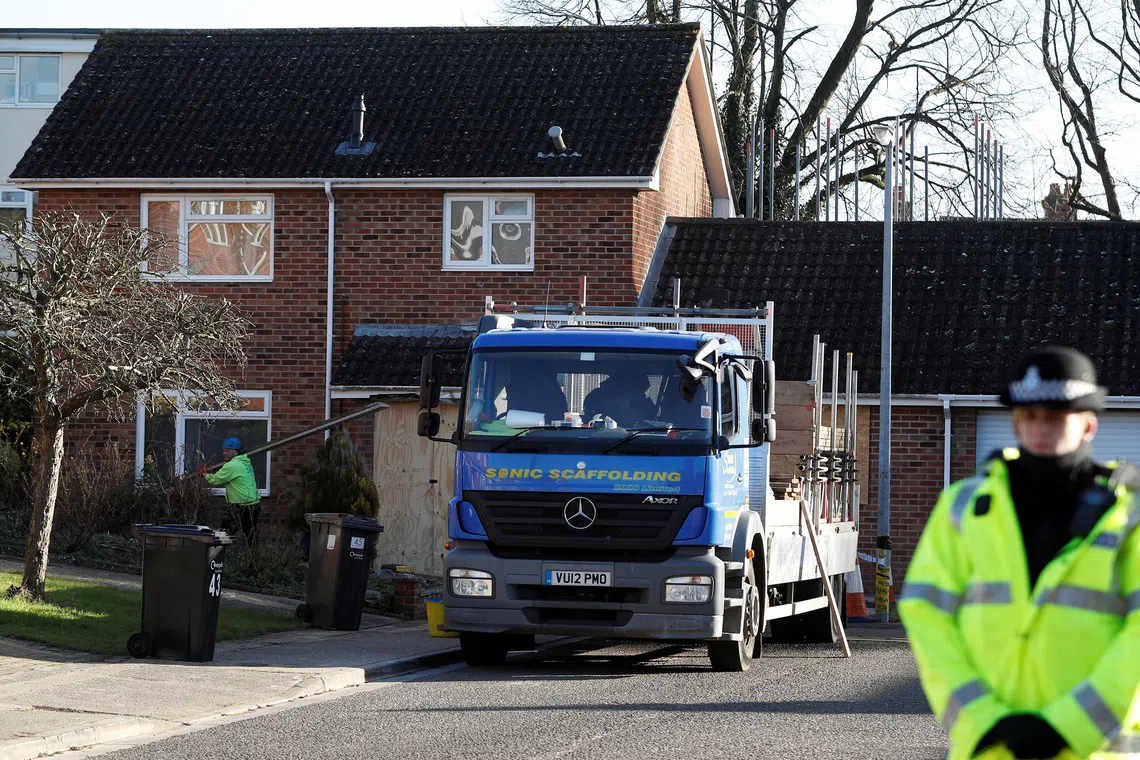 A police officer stands guard as a scaffolder works at the site of former spy Sergei Skripal's house, in Salisbury, Britain January 9, 2019. REUTERS/Peter Nicholls