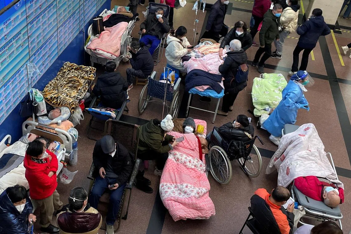 Patients lie on beds and stretchers in a hallway, in the emergency department of a hospital, in Shanghai, China, on Jan 4, 2023.