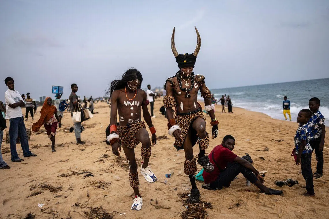 Itinerant performers walking on the beach in Lome, Togo on March 1, 2026. 
