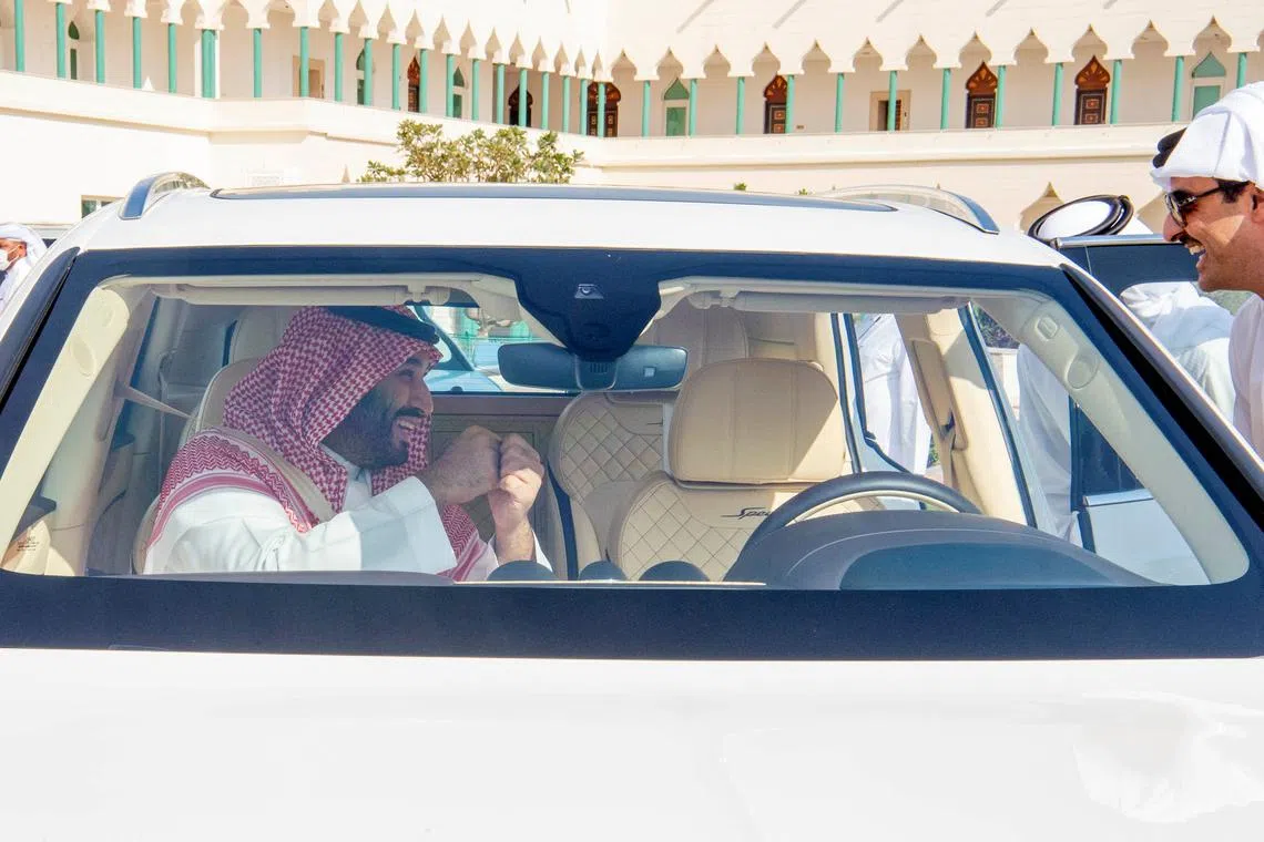 Saudi Crown Prince Mohammed Bin Salman talks to the Emir of Qatar, Sheikh Tamim bin Hamad Al Thani, during his visit to Doha, Qatar, December 9, 2021 Bandar Algaloud/Courtesy of Saudi Royal Court/Handout via REUTERS/File Photo