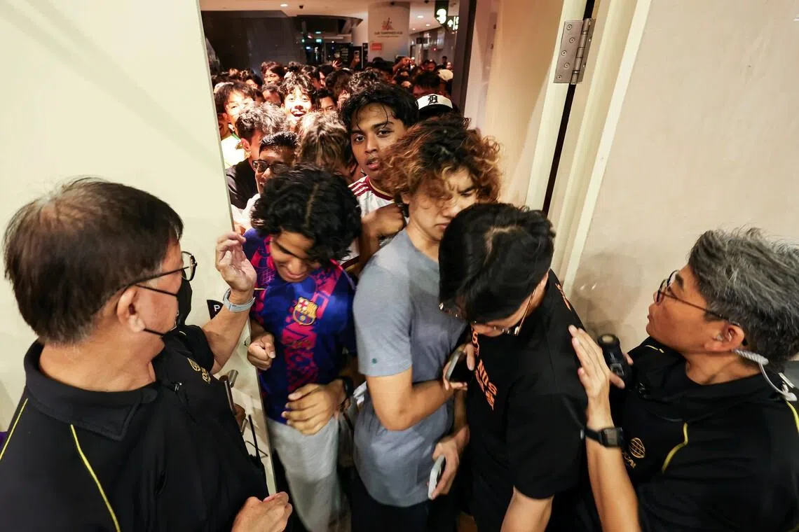 Security personnel restricting entry after the Our Tampines Hub community auditorium reached full capacity for a live screening of the FIFA World Cup 2026 final between Argentina and Spain in the early hours of July 20, 2026. ST PHOTO: BRIAN TEO