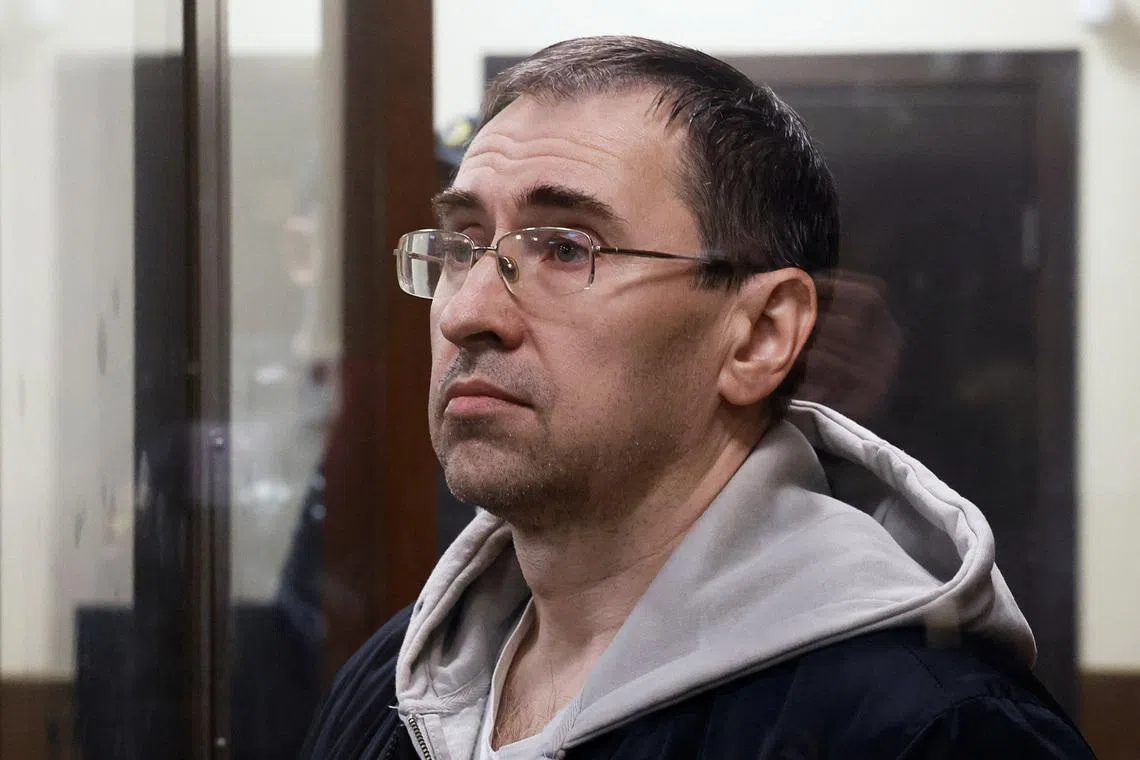 Oleg Roldugin, an investigative journalist for the independent Russian newspaper Novaya Gazeta, who was detained in a case involving alleged misuse of personal data, stands inside an enclosure for defendants before a court hearing in Moscow, Russia April 10, 2026. REUTERS/Stringer