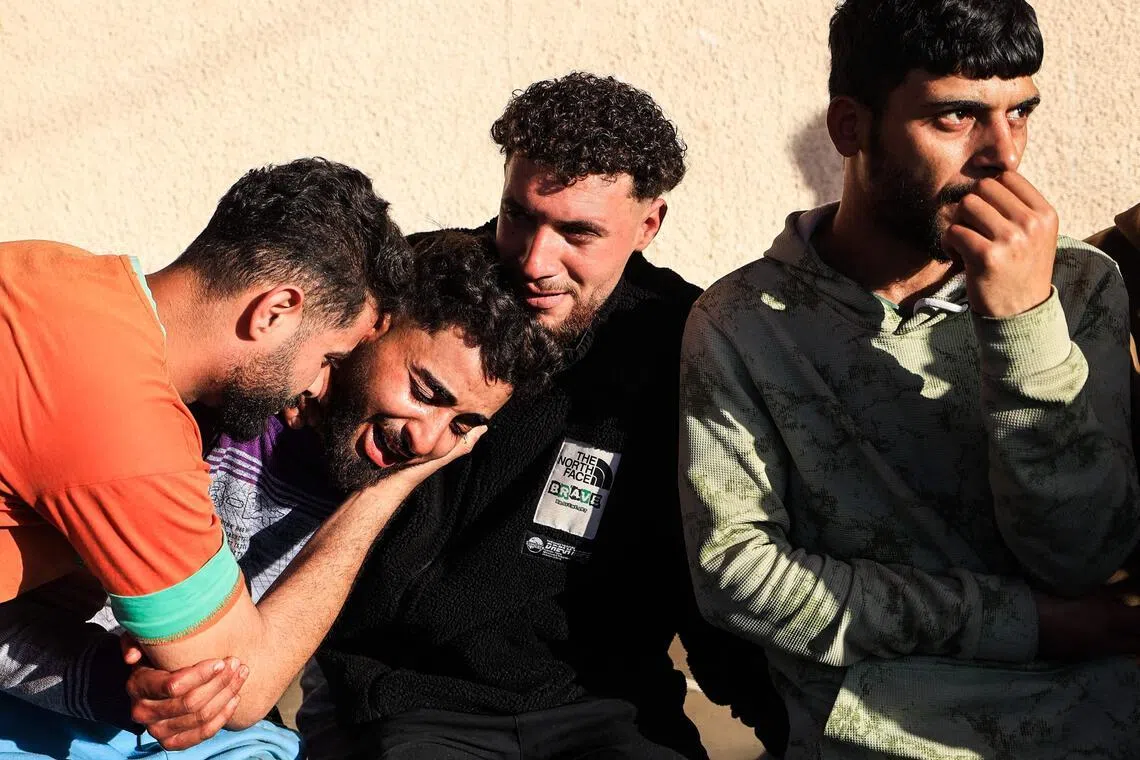 Family members react outside the Al-Aqsa Martyrs Hospital in Deir al-Balah, where victims have been brought following an Israeli strike.