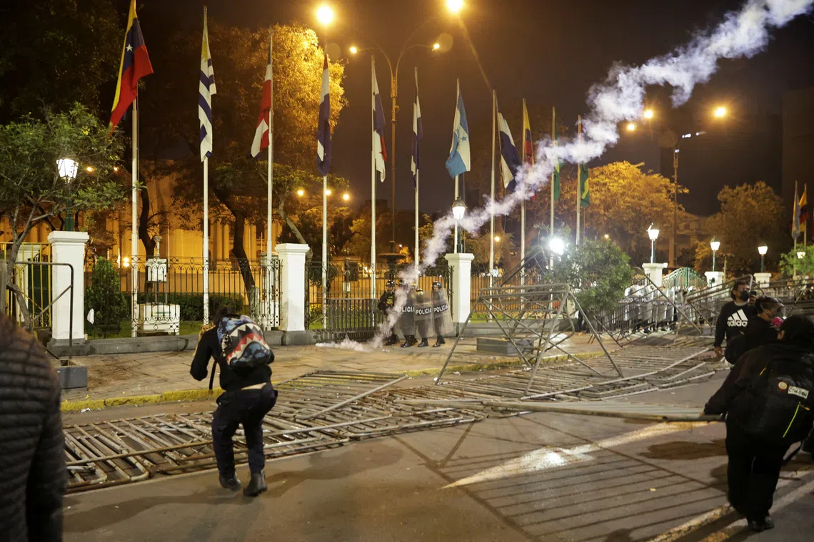 FILE PHOTO: Police officers shield themselves as protesters threw a tear gas bomb back at them during a demonstration organised by a youth collective called \"Generation Z\" to express discontent over a controversial pension reform plan, as well as the government of Peru's President Dina Boluarte, whose approval ratings have plummeted due to ongoing scandals and rising crime, in Lima, Peru, September 28, 2025. REUTERS/Sebastian Castaneda/File Photo