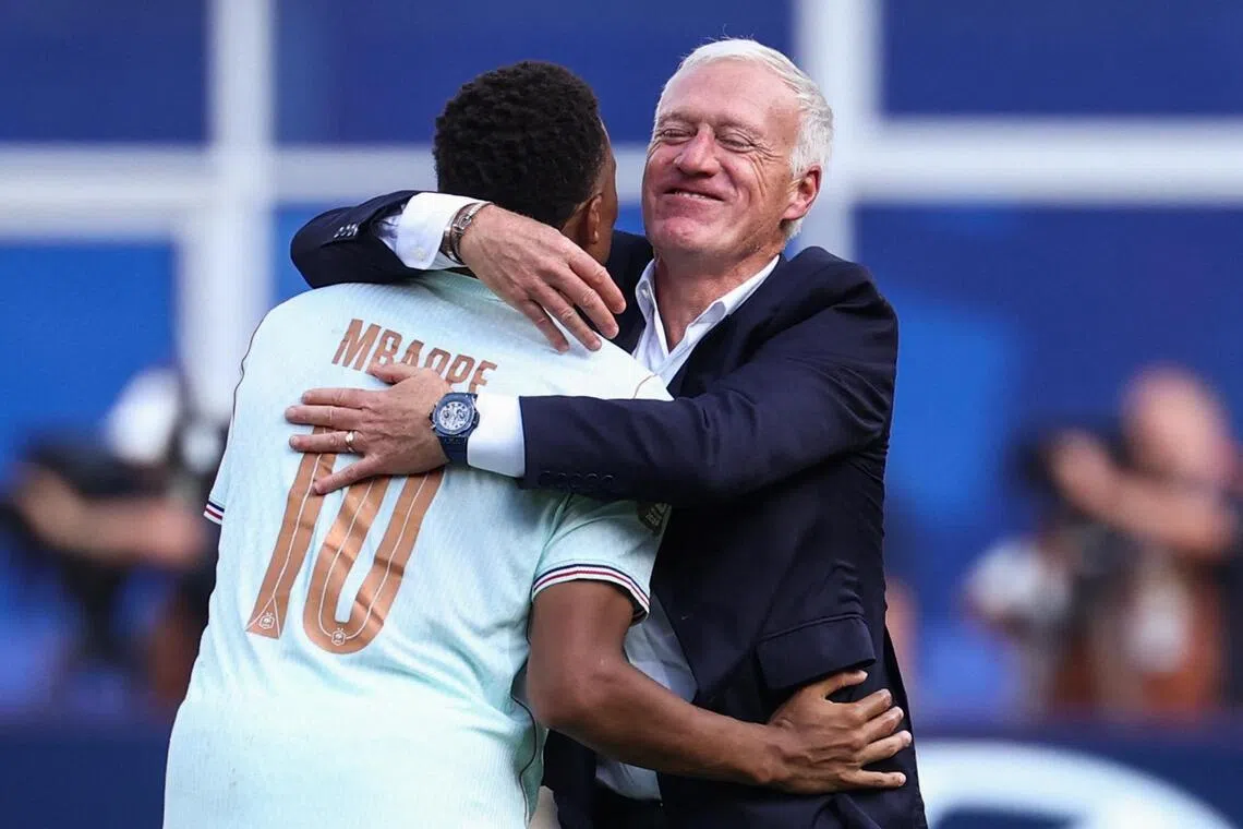 TOPSHOT - France's forward #10 Kylian Mbappe and head coach Didier Deschamps hug after winning the 2026 World Cup football tournament quarter-final match between France and Morocco at Boston Stadium in Foxborough on July 9, 2026.  (Photo by FRANCK FIFE / AFP)