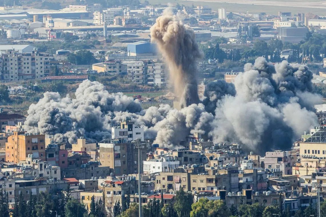 Smoke plumes rise after an Israeli air strike on a neighborhood in southern Beirut on Nov 14.