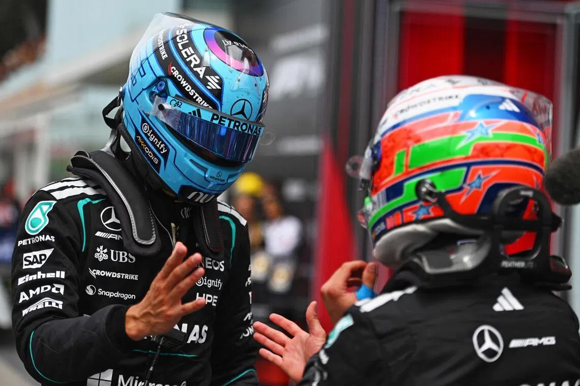 Sprint winner George Russell (left) and teammate Kimi Antonelli speaking in parc ferme after the May 23 race.