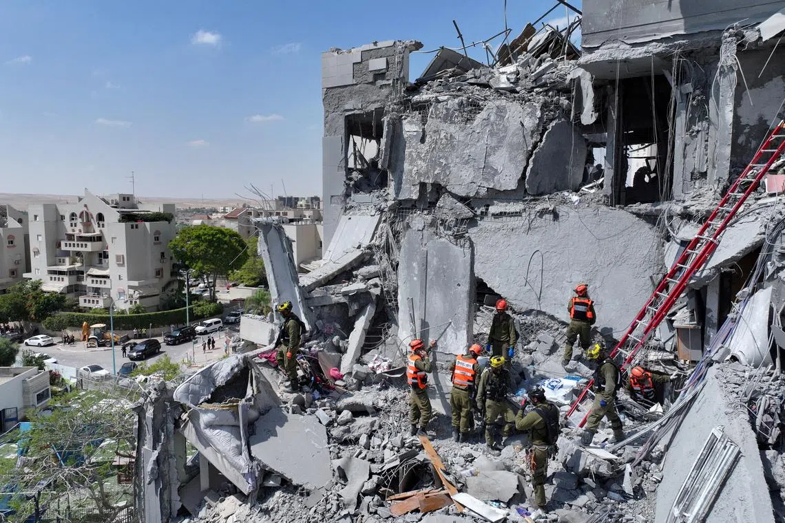 Emergency personnel working at a residential site, following a missile attack from Iran on Israel, in Beersheba, Israel on June 24.