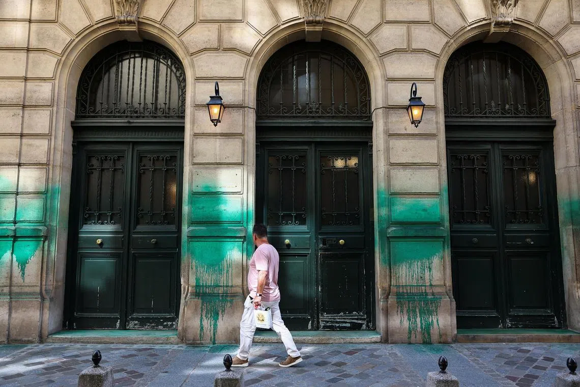 A man walking past the Grande Synagogue des Tournelles, after it was covered in green paint, in Paris, France, on May 31.