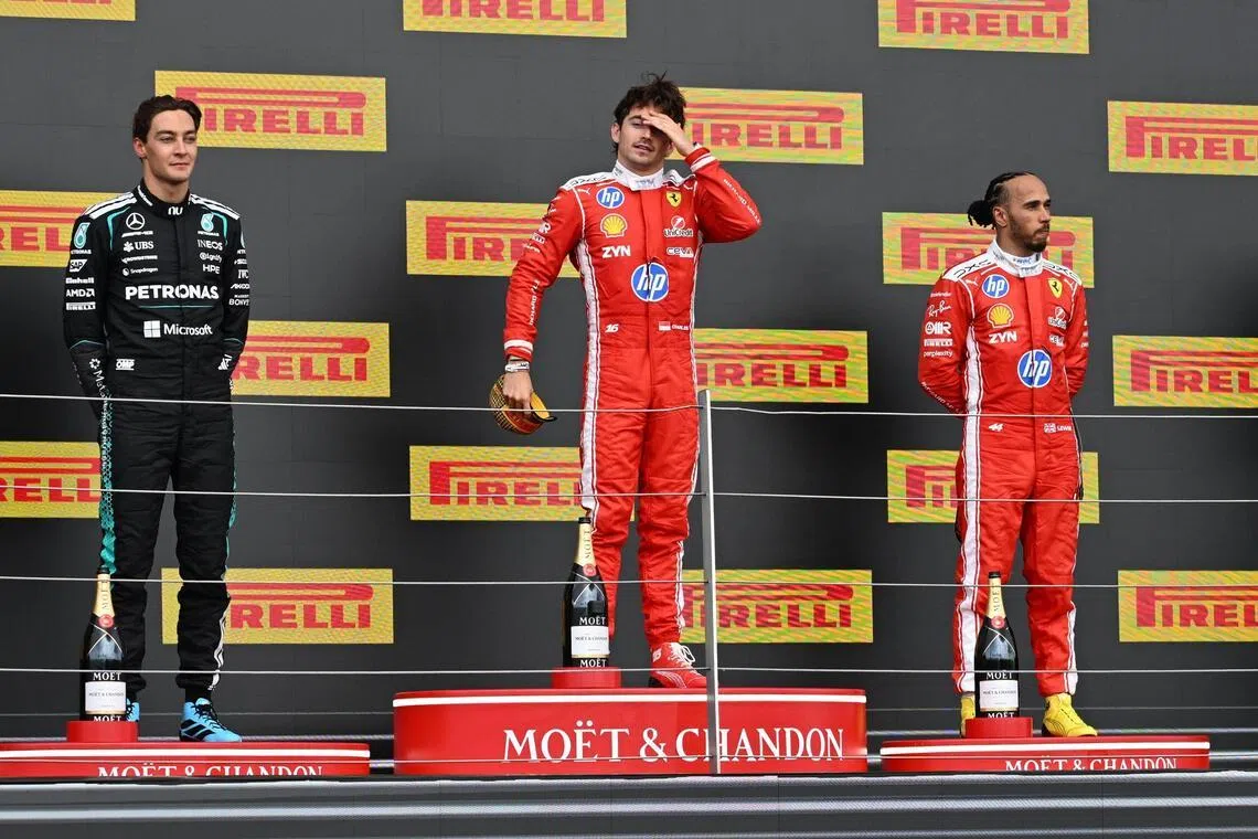 epa13089319 (L-R) Second-placed Mercedes driver George Russell of Britain, first-placed Scuderia Ferrari driver Charles Leclerc of Monaco, and third-placed Scuderia Ferrari driver Lewis Hamilton of Britain celebrate on the podium after the Formula One British Grand Prix at the Silverstone Circuit racetrack in Silverstone, Britain, 05 July 2026.  EPA/PETER POWELL