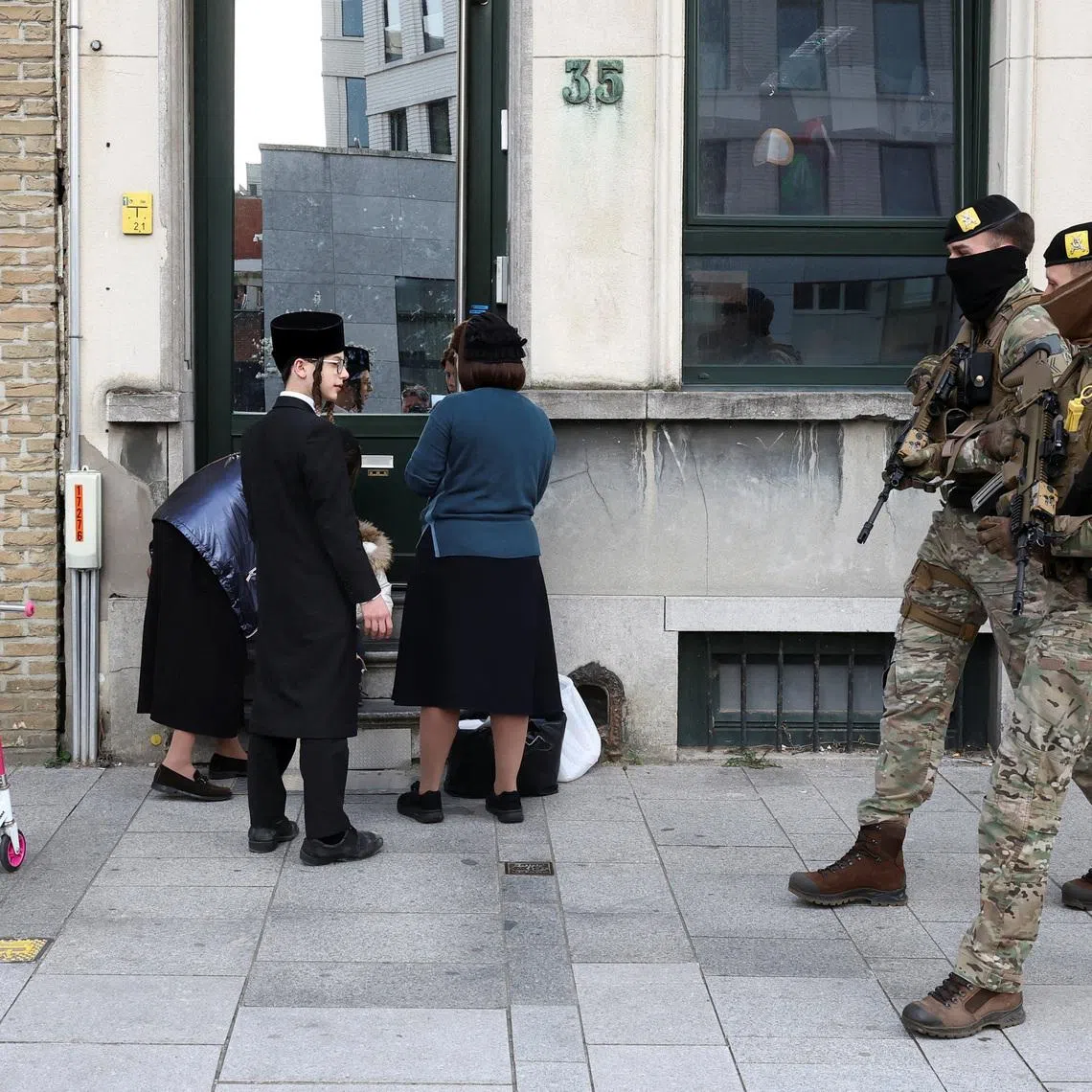 Belgian army personnel patroll a street as part of a deployment of soldiers outside Jewish institutions in Antwerp and Brussels following attacks at Jewish sites in Belgium and other European countries, in Antwerp, Belgium, March 23, 2026. REUTERS/Yves Herman
