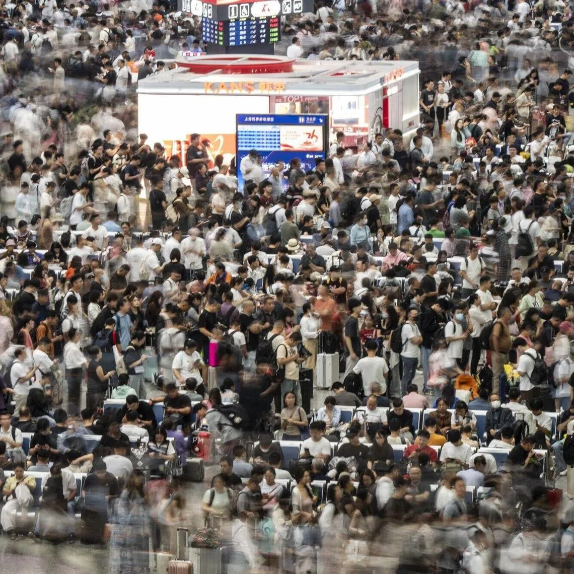 Travelers at Hongqiao Highspeed Railway Station ahead of the Golden Week holiday in Shanghai, China, on Tuesday, Sept. 30, 2025. Millions are expected to travel, shop and dine during China's eight-day Golden Week holiday starting Wednesday, which usually boosts economic activity across the country. Photographer: Qilai Shen/Bloomberg