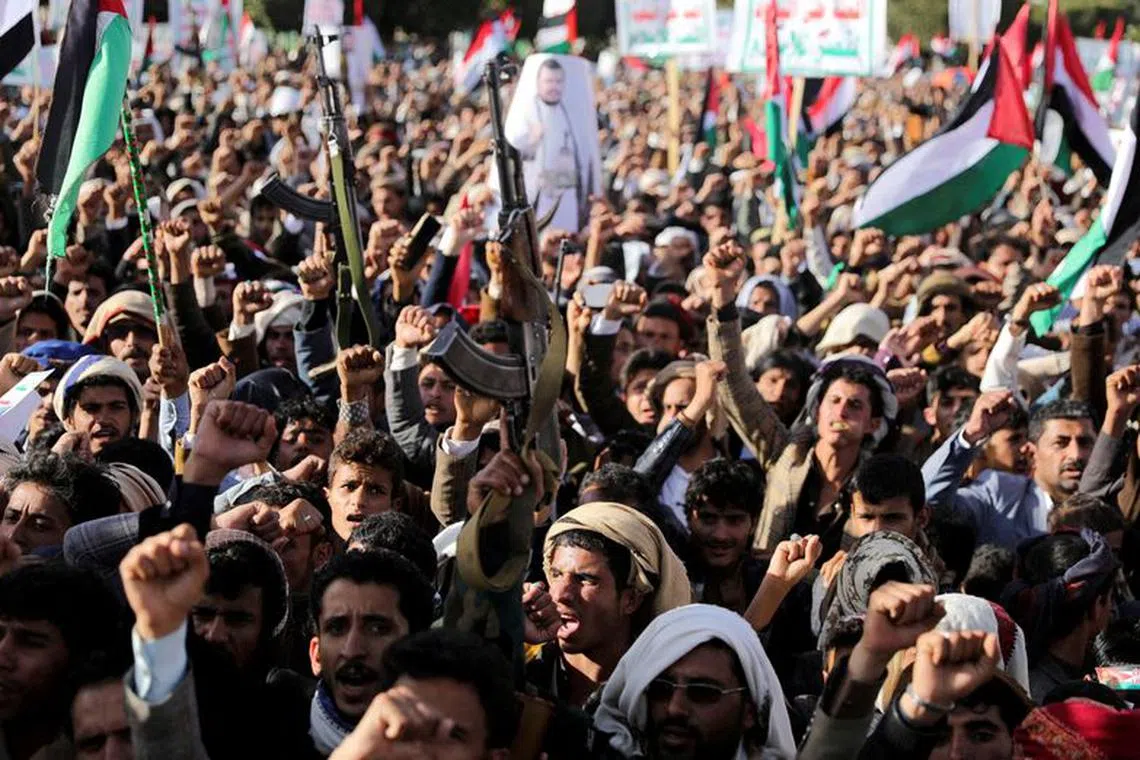 FILE PHOTO: Supporters of the Houthi movement rally to denounce air strikes launched by the U.S. and Britain on Houthi targets, in Sanaa, Yemen January 12, 2024. REUTERS/Khaled Abdullah/File Photo