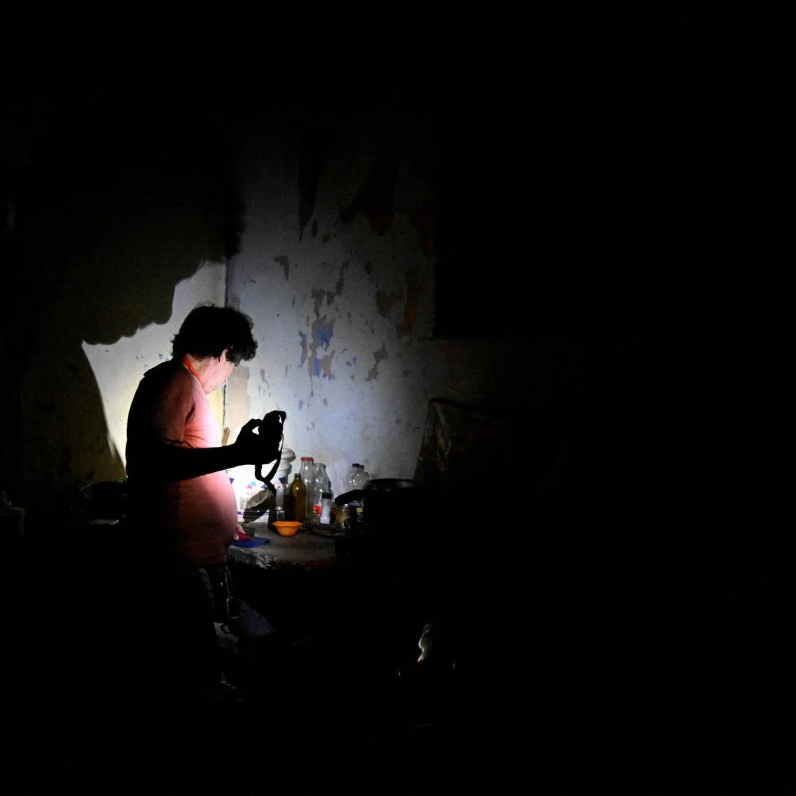 A man uses a flashlight during a blackout as Cuba's national electric grid collapsed, according to the country's grid operator, leaving around 10 million people without power amid a U.S.-imposed oil blockade, in Havana, Cuba. REUTERS/Norlys Perez