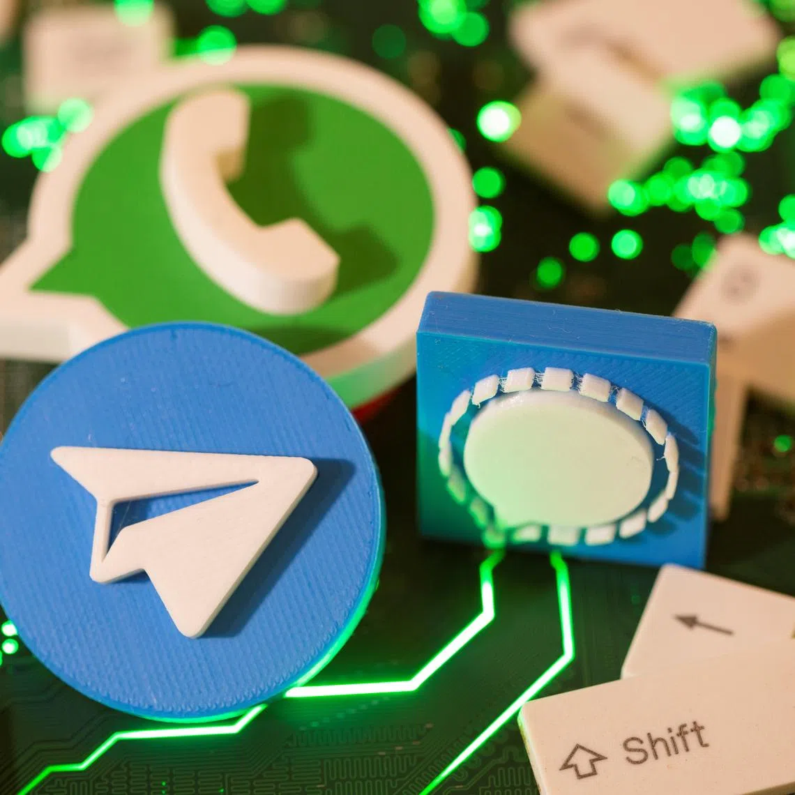 3D printed Telegram, Signal and WhatsApp logos and keyboard buttons are placed on a computer motherboard in this illustration taken January 21, 2021. REUTERS/Dado Ruvic/Illustration