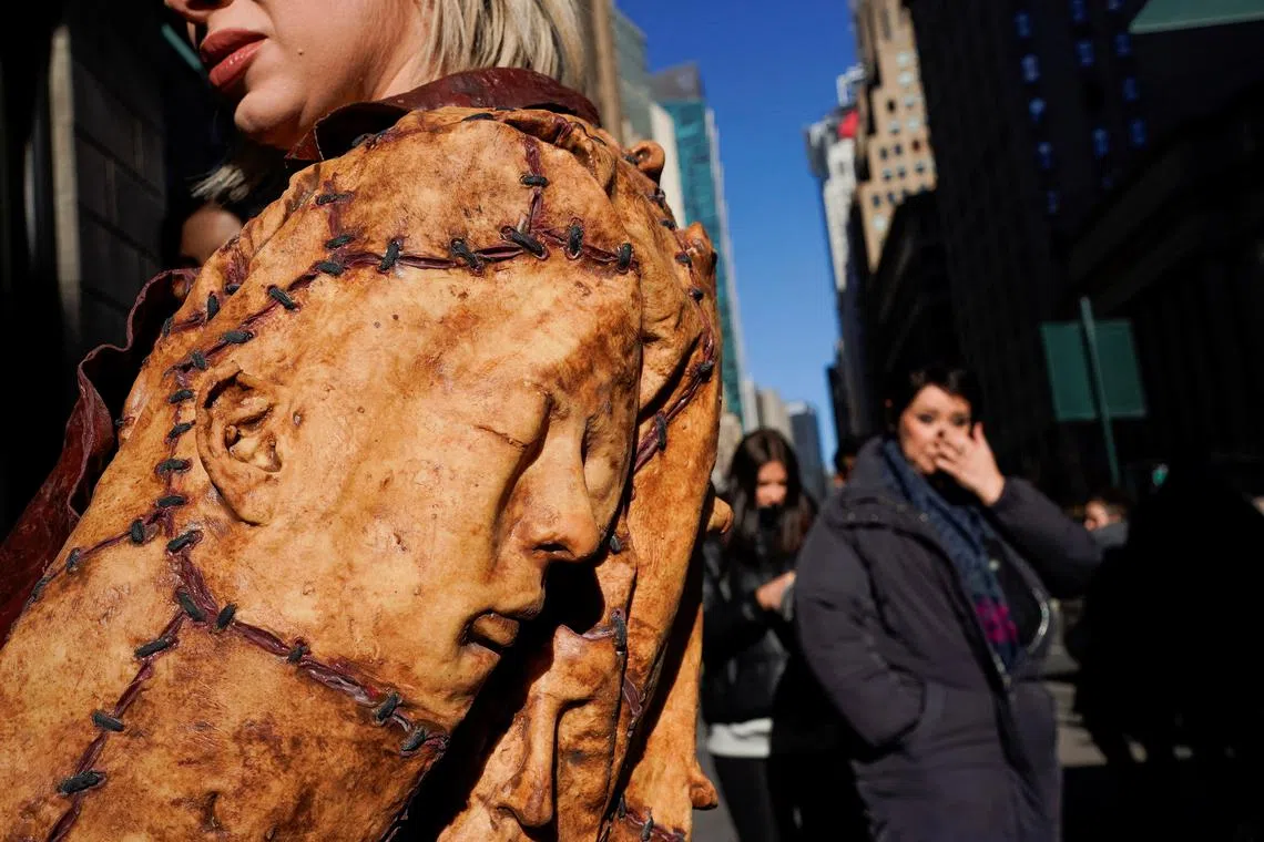 A PETA's model displays a design made of hyperrealistic "human leather" during a protest outside Urban Outfitter store in New York City, U.S., December 14, 2022. 