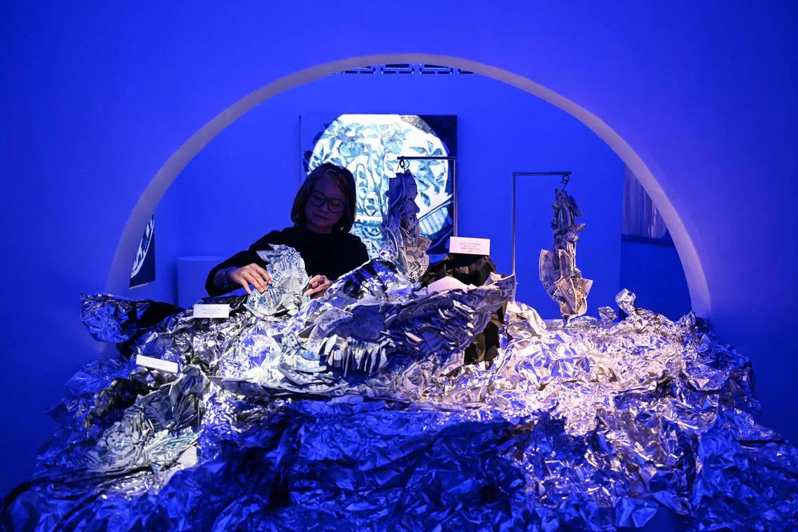 This picture taken on July 24, 2025 shows Malaysian artist Alice Chang posing for pictures next to shards of porcelain rescued from the historic 400-year-old Portuguese Wanli shipwreck and turned into sculptures at a gallery in Ampang, Malaysia's Selangor state. Chinese porcelain shards salvaged from a famous shipwreck are being reimagined in Malaysia, hundreds of years after the Portuguese vessel is said to have sunk in battle. (Photo by Mohd RASFAN / AFP) / RESTRICTED TO EDITORIAL USE - MANDATORY MENTION OF THE ARTIST UPON PUBLICATION - TO ILLUSTRATE THE EVENT AS SPECIFIED IN THE CAPTION

To go with "MALAYSIA-ART-HISTORY-SHIPWRECK-ART,FOCUS" by Isabelle LEONG