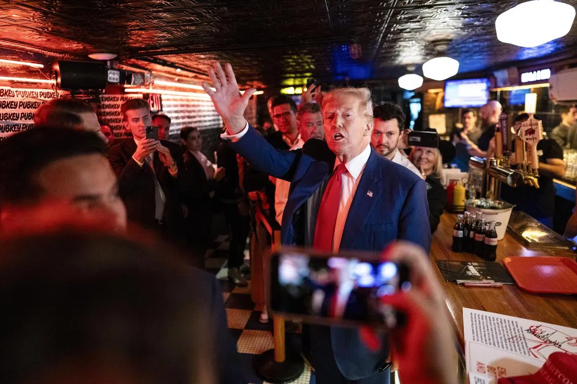 Trump was met with heavy applause from a mixture of self-identified Bitcoin enthusiasts and Trump supporters when he entered the dimly lit bar.