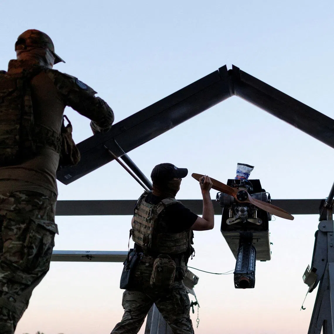 Service members of the 414th Separate Unmanned Strike Aviation System Brigade 'Magyar's Birds' of the Ukrainian Armed Forces write messages to Russians on an FP-1 deep-strike drone before it launches for a combat mission, amid Russia's attack on Ukraine, in an undisclosed location in Ukraine, in 2026. REUTERS/Valentyn Ogirenko
