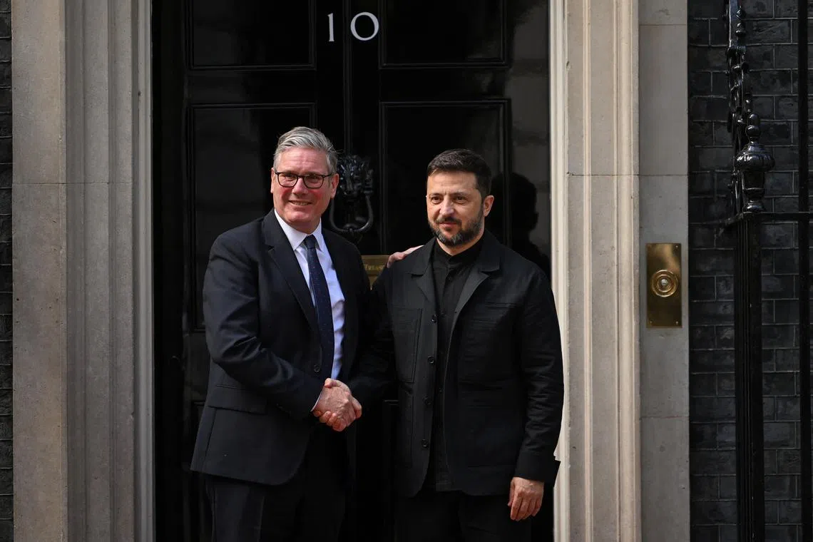 Ukrainian President Volodymyr Zelenskiy shakes hands with British Prime Minister Keir Starmer at 10 Downing Street, in London, Britain, June 23, 2025. REUTERS/Jaimi Joy/File Photo