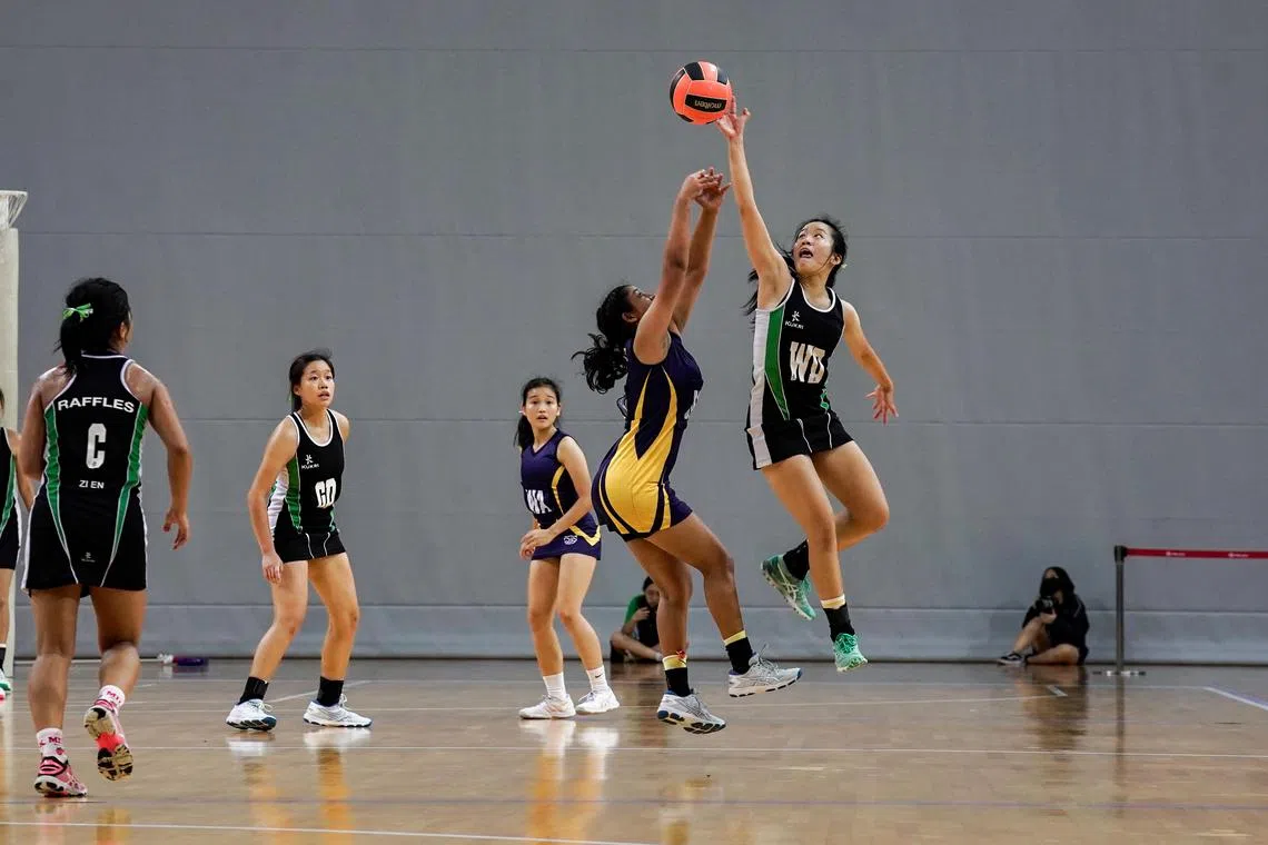 ST20230524_202341784455-Eugene Tan-Jam-jamnet24/ 

Raffles Institution's netball player blocking the ball during the National School Games A division netball final on May 24, 2023./

 (ST PHOTO: EUGENE TAN)