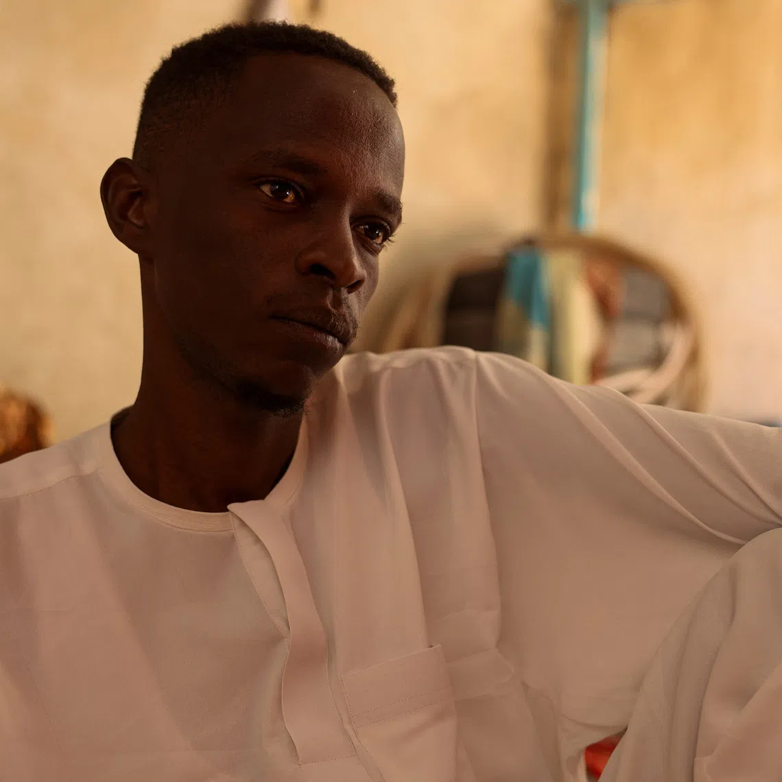 Ibrahim Kitr, 30, a Sudanese refugee from al-Fashir who was held captive for two days by the paramilitary Rapid Support Forces (RSF) in northeast al-Fashir after the city was captured, until his family paid 35 million Sudanese pounds for his release, looks on during an interview with Reuters in Tine, eastern Chad, November 24, 2025. REUTERS/Amr Abdallah Dalsh