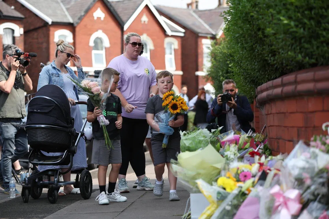 epa11508541 People leave tributes at the scene of a stabbing attack on Hart Street in Southport, Britain, 30 July 2024. Merseyside Police confirmed on 30 July that a third child aged 9 has died as a result of a knife attack in Southport the previous day, and confirmed that the other two victims were ages six and seven respectively. Five other children and two adults remain in critical condition. Armed police detained a 17-year-old boy on suspicion of murder and attempted murder, while the motivation for the attack was not being treated as terrorist related.  EPA-EFE/ADAM VAUGHAN