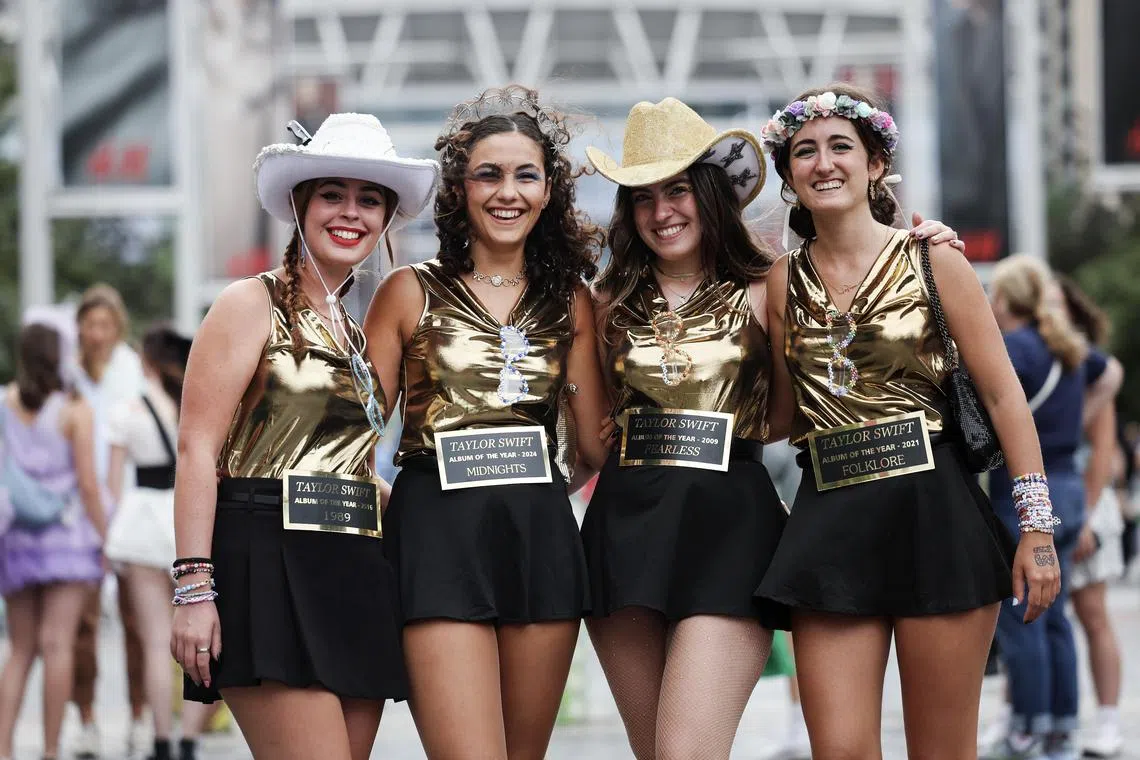 epa11550222 Taylor Swift fans pose for photographs outside Wembley Stadium before the first of the Eras Tour concerts at Wembley Stadium, in London, Britain, 15 August 2024. The last concerts of US pop star's Eras Tour in Europe take place at London's Wembley Stadium from 15 to 20 August 2024. The concerts will go ahead amid additional security measures following the cancellation of Swift's three shows in Vienna earlier in August 2024. London Metropolitan Police's spokesperson had said that 'There is nothing to indicate that the matters being investigated by the Austrian authorities will have an impact on upcoming events here in London.'  EPA-EFE/ANDY RAIN