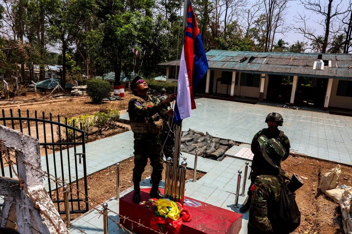 LT Saw Kaw, a soldier of the Karen National Liberation Army (KNLA) in charge of the Cobra column, raises Karen's national flag after burning Myanmar's national flag at a Myanmar military base at Thingyan Nyi Naung village on the outskirts of Myawaddy, the Thailand-Myanmar border town under the control of a coalition of rebel forces led by the Karen National Union, in Myanmar, April 15, 2024. REUTERS/Athit Perawongmetha