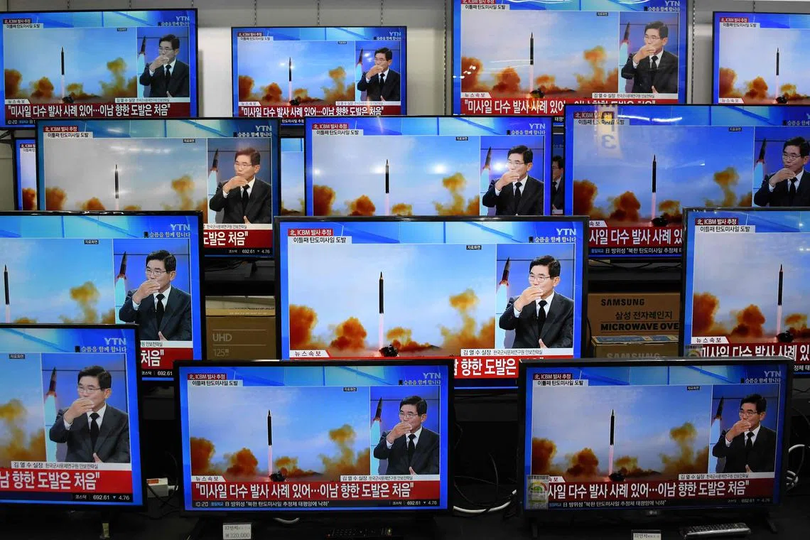 Television screens at an electronic market in Seoul show a news report about Thursday's North Korean missile launch.