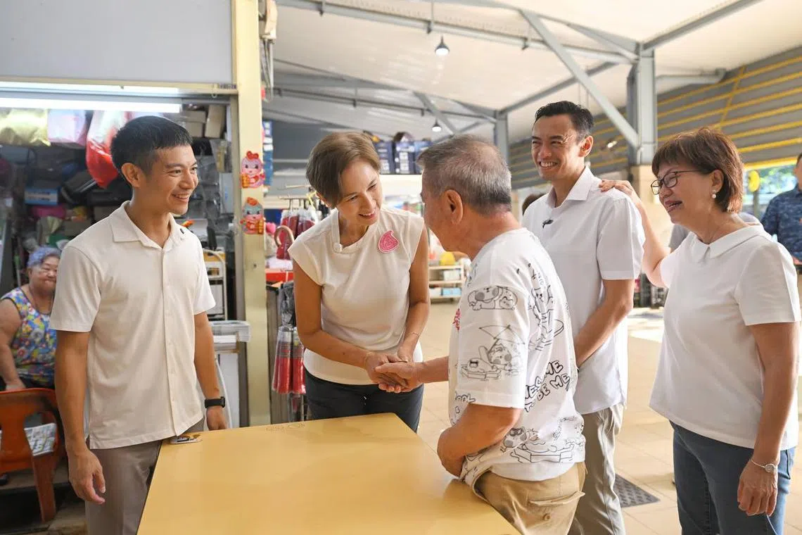 PAP new face Shawn Loh, Minister for Digital Development and Information Josephine Teo, Dr Wan Rizal Wan Zakariah and Ms Denise Phua on a walkabout at Sims Vista Market and Food Centre on April 19.