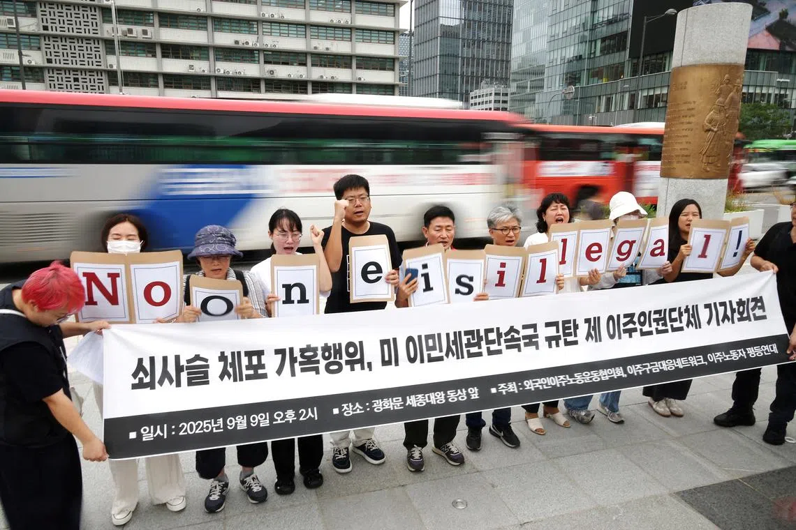 Activists holding signs that reads \"No one is illegal!\", chant slogans during a press conference to protest against a huge immigration raid last week at the site of a U.S. car battery project involving Hyundai Motor and LG Energy Solution in the U.S. state of Georgia, in front of the U.S. embassy in Seoul, South Korea, September 9, 2025. REUTERS/Kim Hong-Ji
