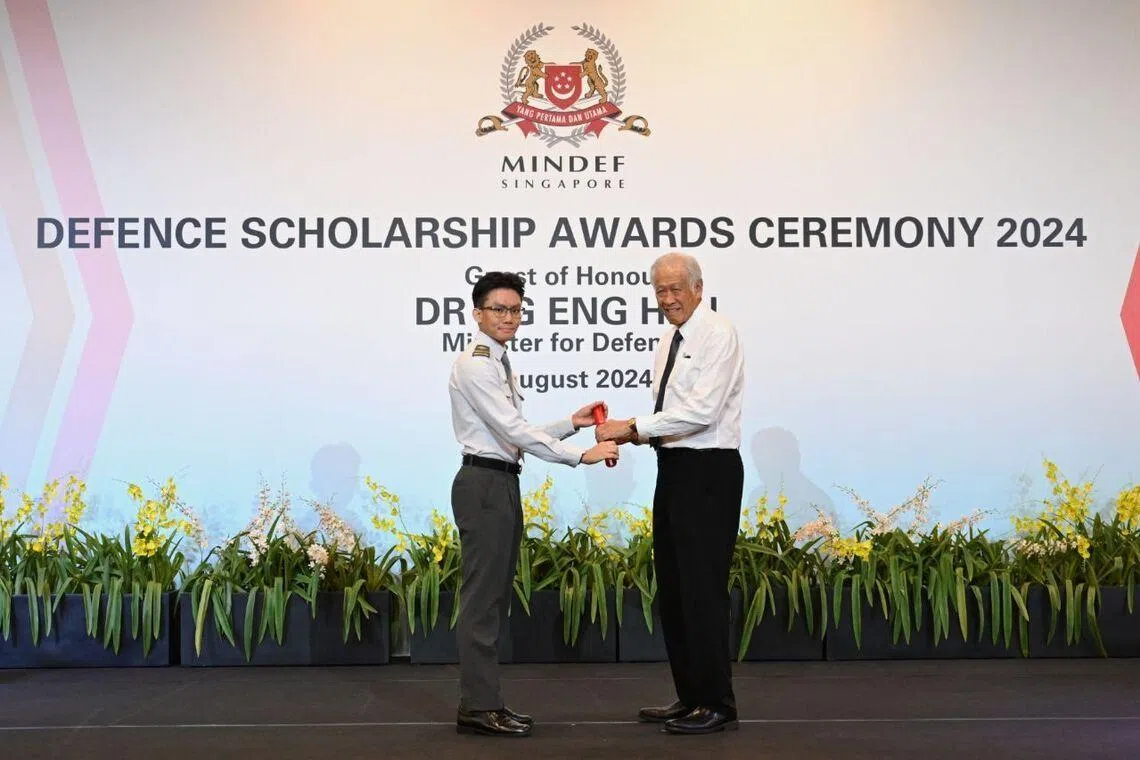 me4 apprentice dexter chow receiving the mid-term saf merit scholarship from then defence minister ng eng hen in 2024