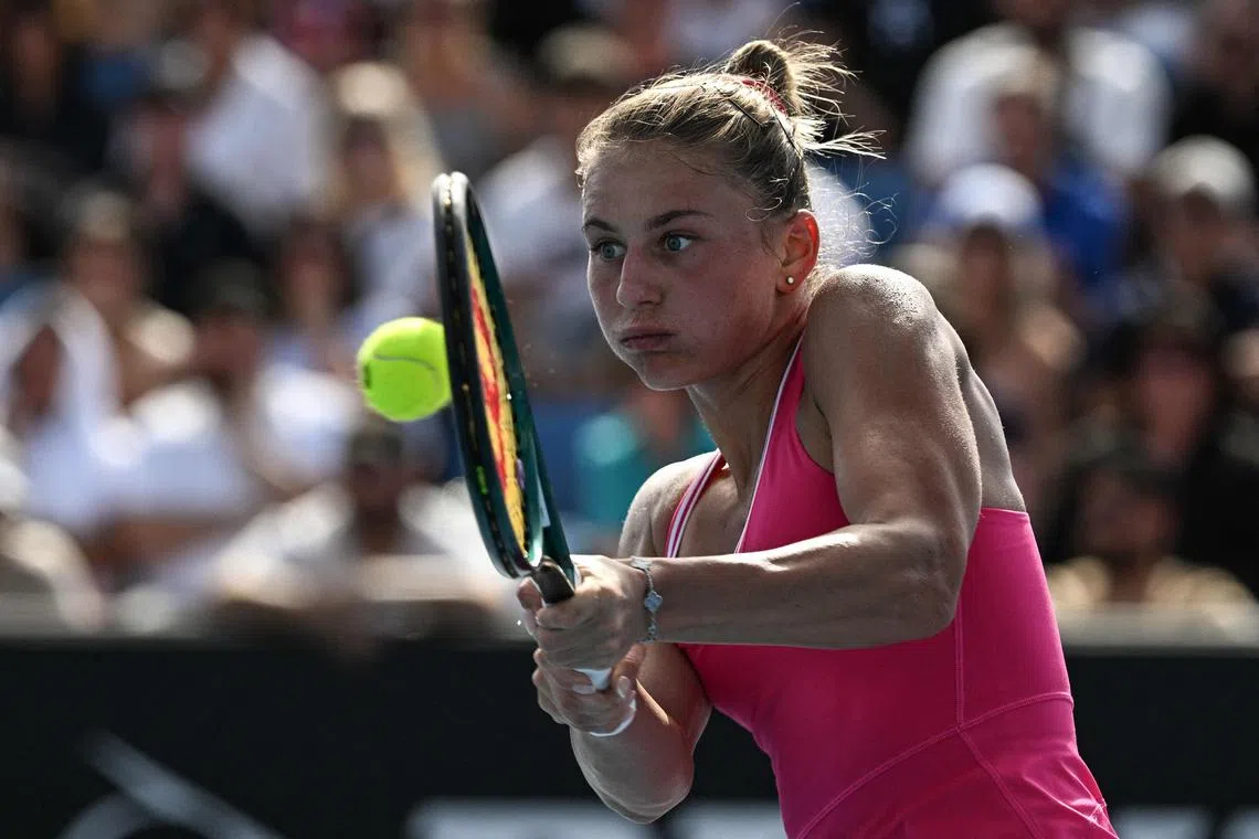 Ukraine's Marta Kostyuk hits a return against Russia's Elina Avanesyan.