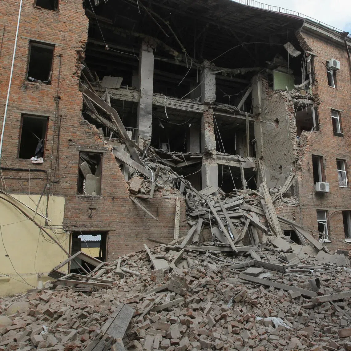 Municipal workers removing debris after Russian drones hit a residential building in Dnipro, Ukraine, on April 25.